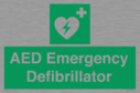 green-background-with-white-text-and-heart-defibrillator-symbol--white-cross-and~